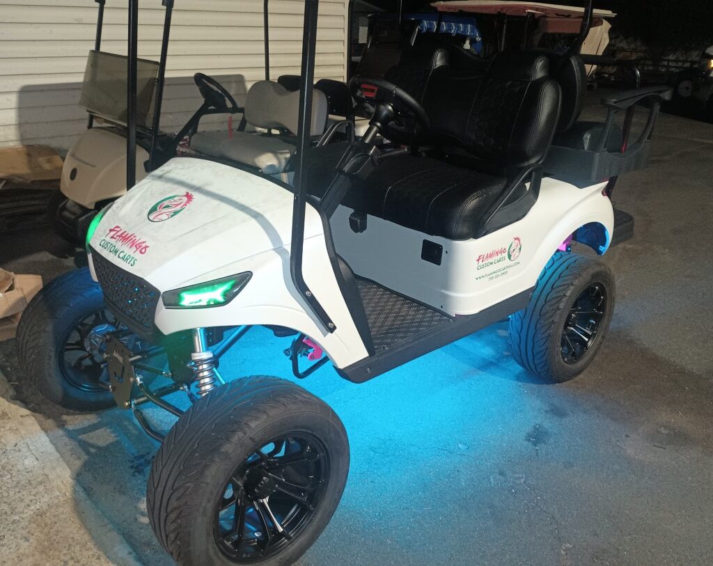 A white golf cart with blue LED lights. Golf cart customization kits, Atlanta golf carts, Flamingo Custom Carts, custom golf carts Atlanta, golf cart accessories Atlanta, LED lights for golf carts, luxury golf cart seating